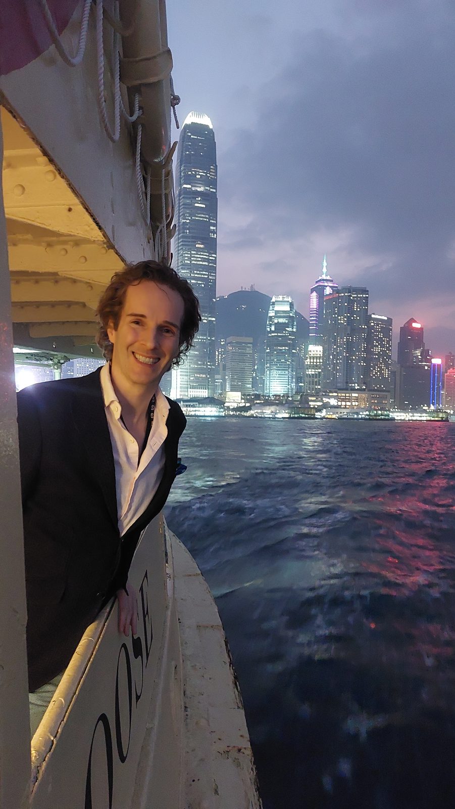 Nikolas Prehn (Felix Nikolas Prehn), on a harbour ferry at night with the skyline behind