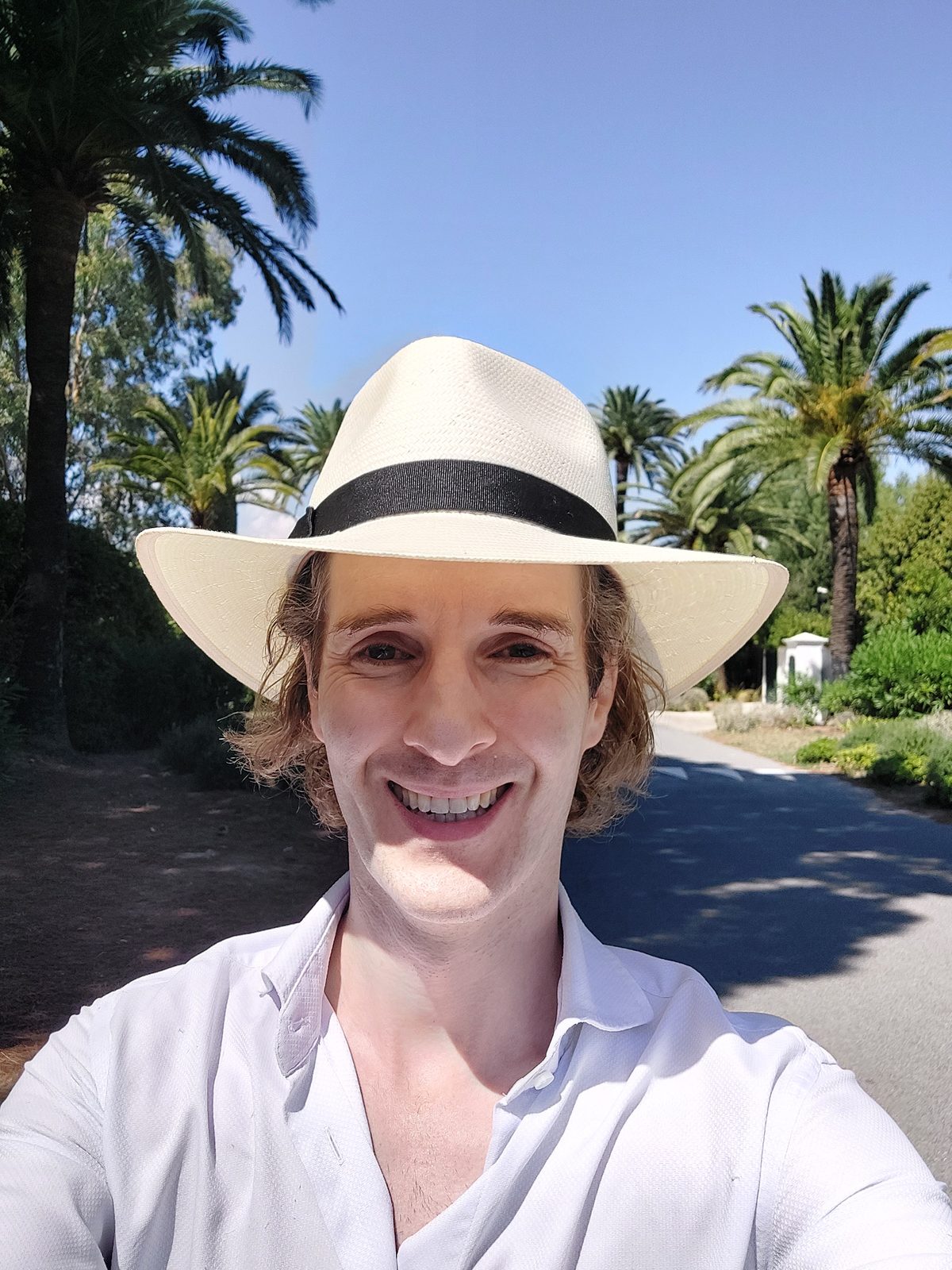 Nikolas Prehn (Felix Nikolas Prehn), in a panama hat among palm trees
